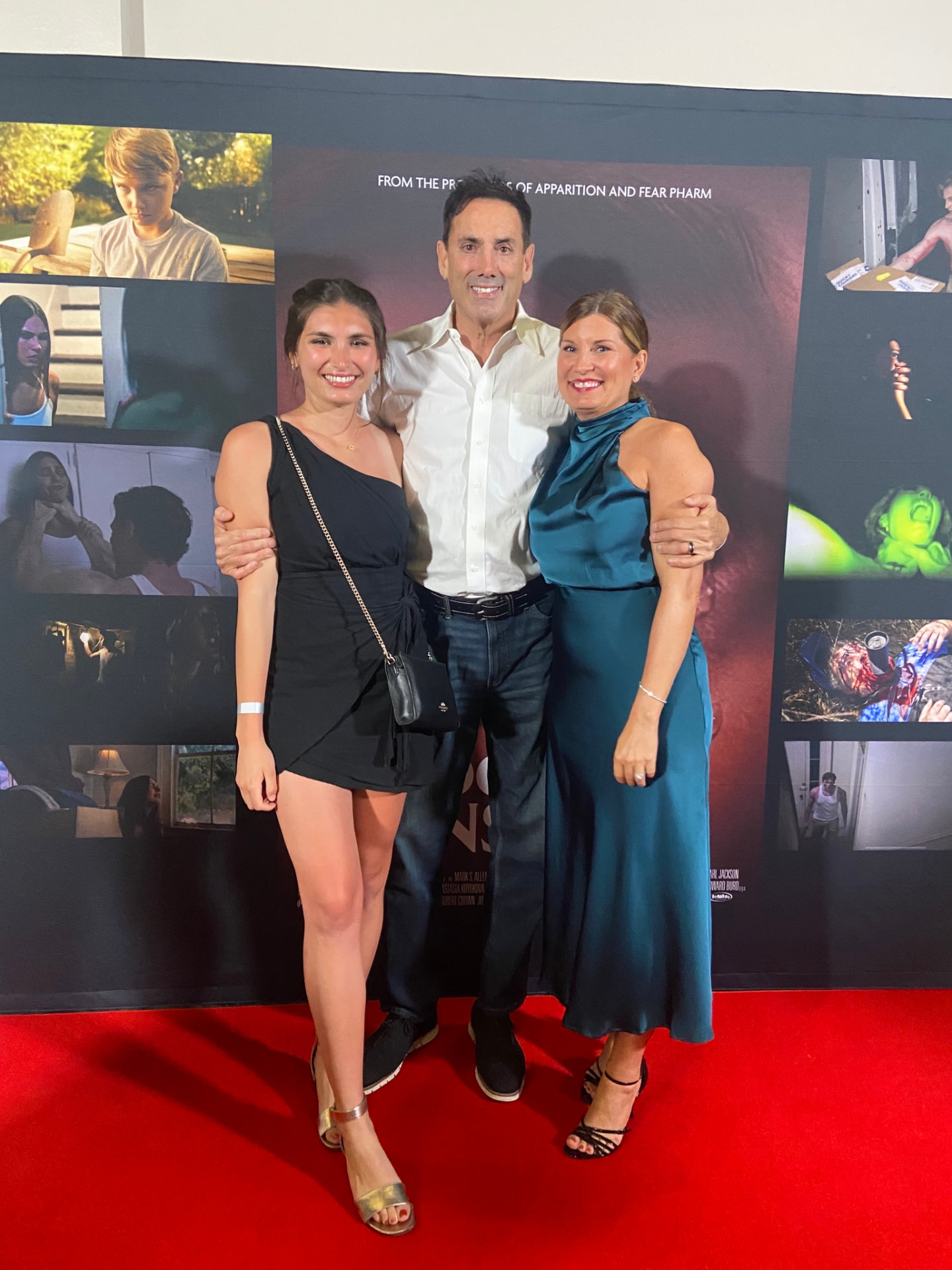 Howard Burd with his family at a film premiere step-and-repeat